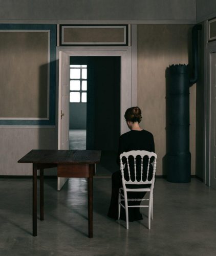 Interior with a Lady in a White Chair